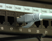Imagen que muestra un conector enchufado a un cuadro de puertos.