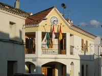 Edificio oficial con las banderas de España, de la comunidad y del ayuntamiento, representativo de una administración pública. 