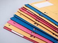 Fotografía que muestra una serie de ficheros o carpetas de colores apiladas.