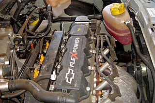 Interior del capó de un vehículo mostrando el motor y otros componentes