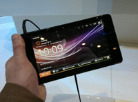 Un usuario sujeta con su mano un pequeño tablet  PC. 